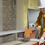Builder using an angle grinder on-site