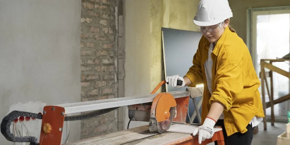 Builder using an angle grinder on-site