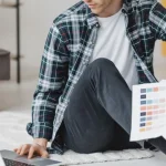 Man sitting on floor with his laptop