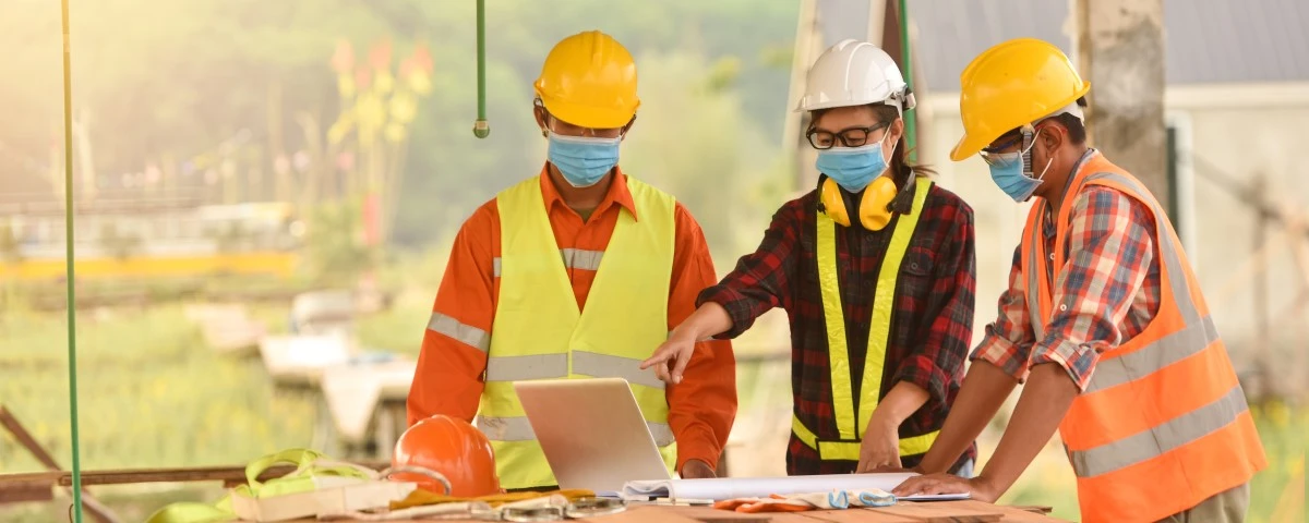 Three builders on-site having a discussion