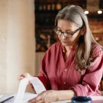 Lady inspecting a receipt at her desk