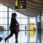 Lady walking through airport terminal