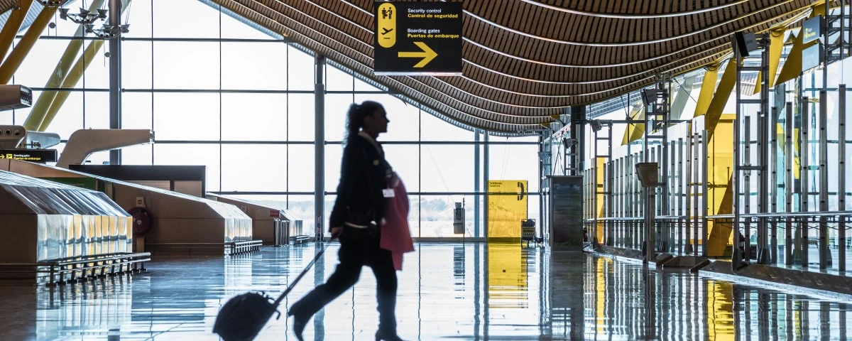 Lady walking through airport terminal