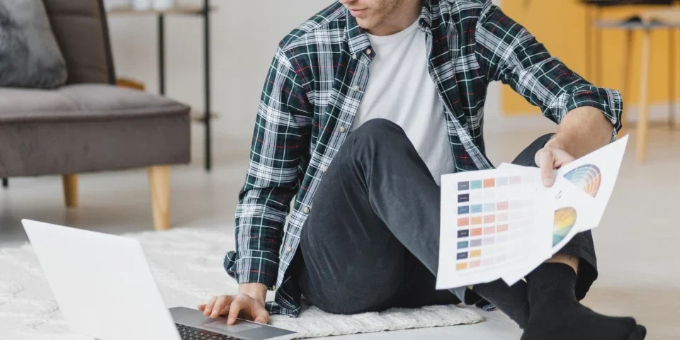 Man sitting on floor with his laptop