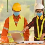 Three builders on-site having a discussion