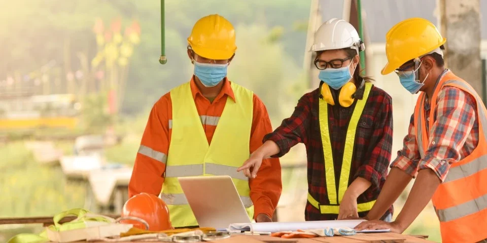 Three builders on-site having a discussion