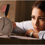 Woman staring intently at clock