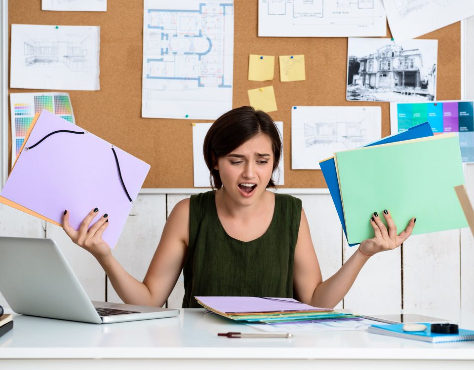 Woman stressing over paperwork.