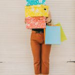 Woman holding boxes - Vinted tax