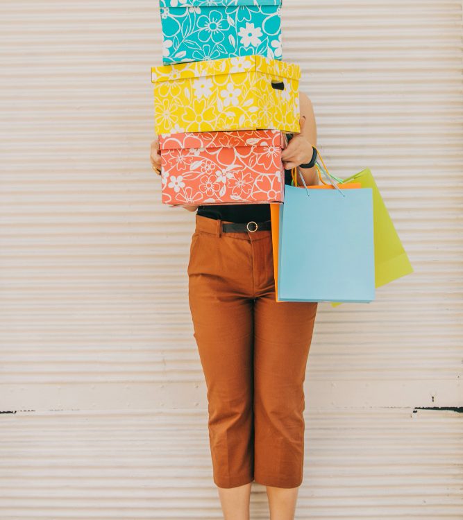 Woman holding boxes - Vinted tax